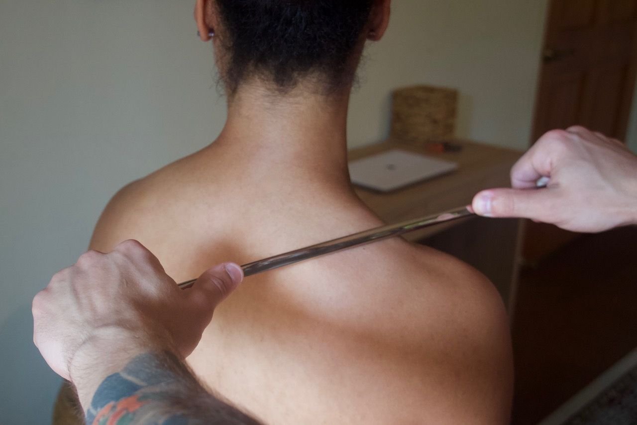 IASTM tool treatment on upper back
